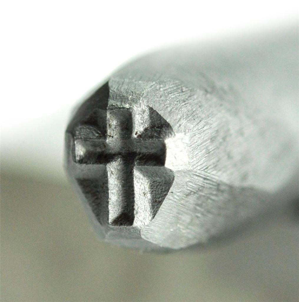 Close-up of 3/16" 5 mm steel cross stamp tool for precision marking in crafts and jewelry making