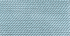 Close-up of turquoise silk bead cord with tight woven texture for jewelry making and crafts, showing smooth, durable threading material
