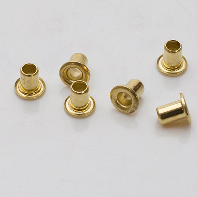 Pack of 24 1/8 inch brass eyelets with semi-rounded heads for crafting and riveting projects