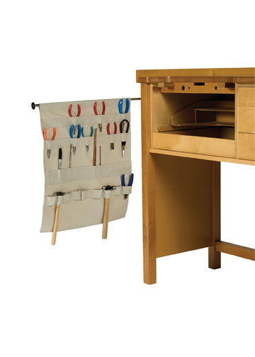 Bench Apron Tool Holder with extension rod hanging on wooden bench organizing pliers and hand tools