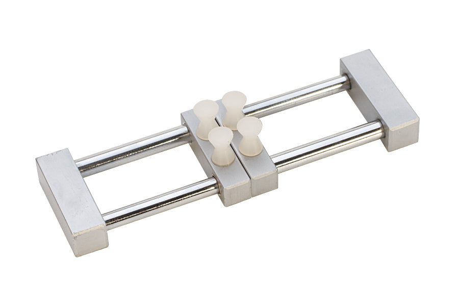 Adjustable slide movement holder with spring-operated sliding clamp and plastic posts for secure, scratch-free workholding up to 36mm width