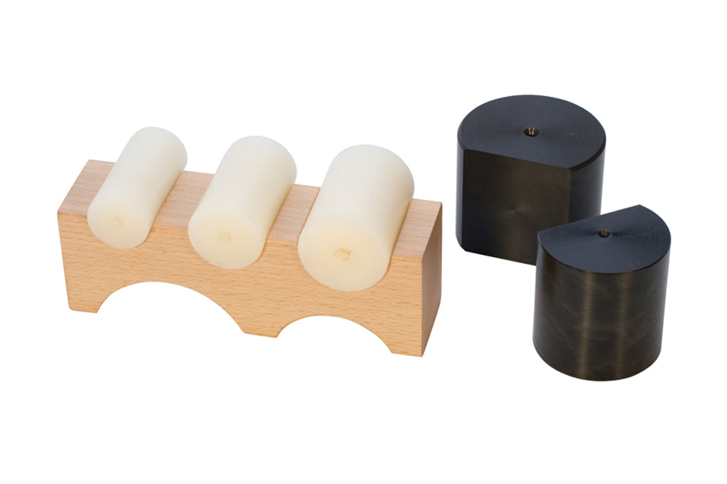 Large wooden shaping block with five white nylon shapers and two black shaping tools for precise bending and crafting.