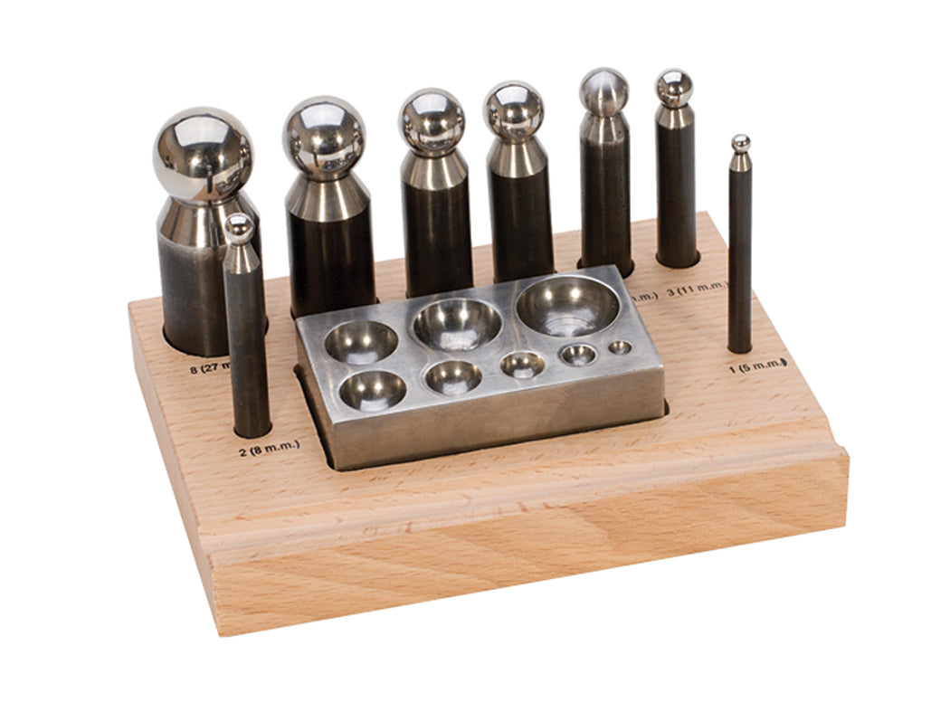 Polished steel dapping set block with 8 punches on wooden base for jewelry making