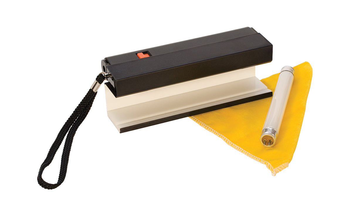 Diamond Gemlight portable lighting tool with Verilux and UV light for diamond and gemstone grading, includes cleaning cloth and battery.