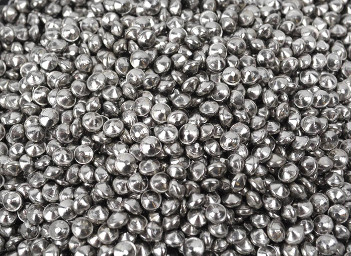 Close-up of large ballcone stainless steel media used for polishing and finishing metal parts