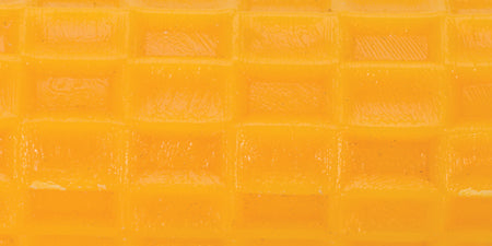 close-up of yellow polymer clay textured with mosaic pattern roller