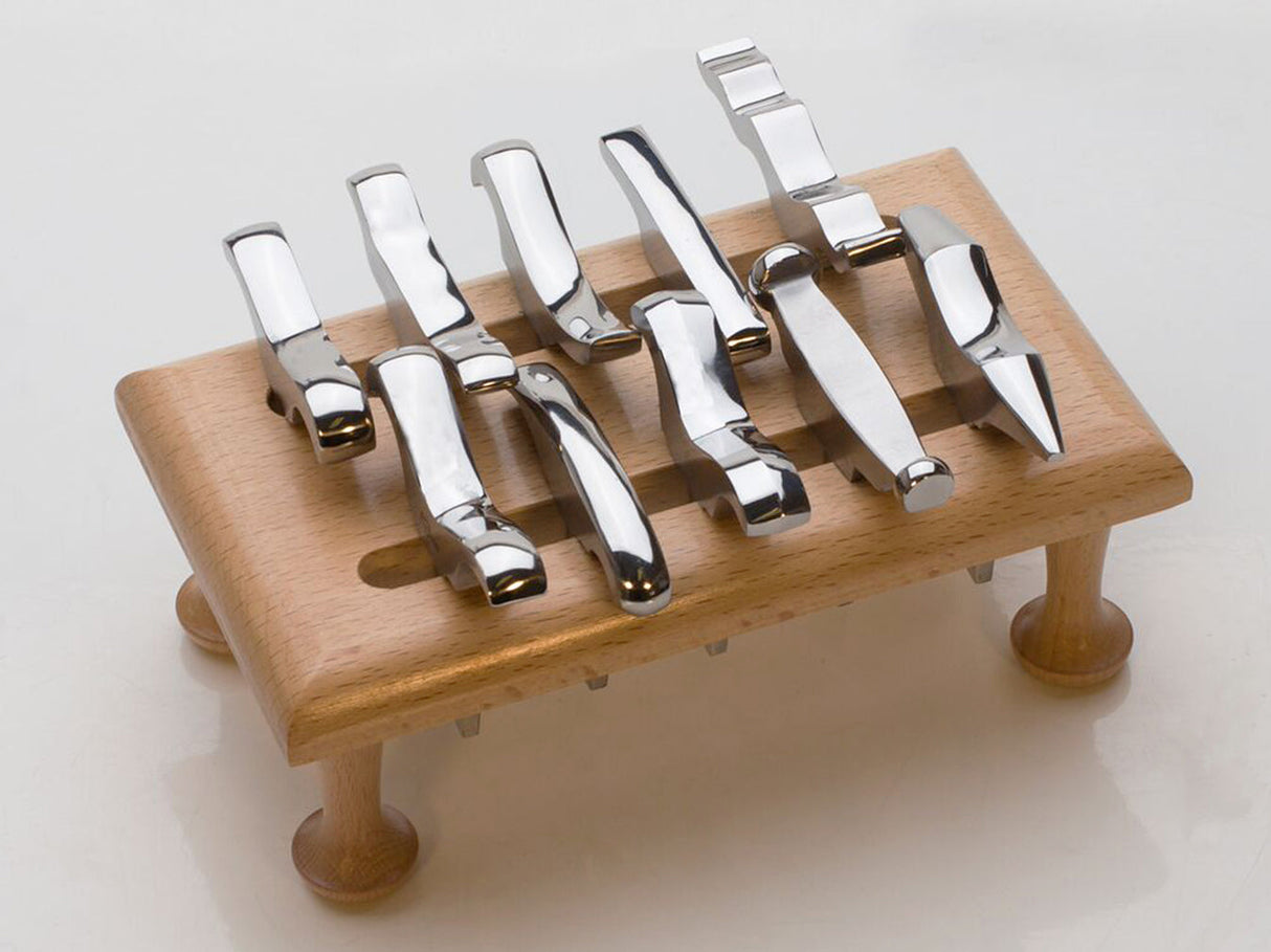 12-piece mini stake forming tool set with polished steel stakes on wooden stand for precision metal shaping