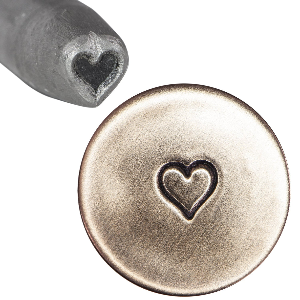 1/4" steel heart stamp tool creating precise heart impression on metal surface