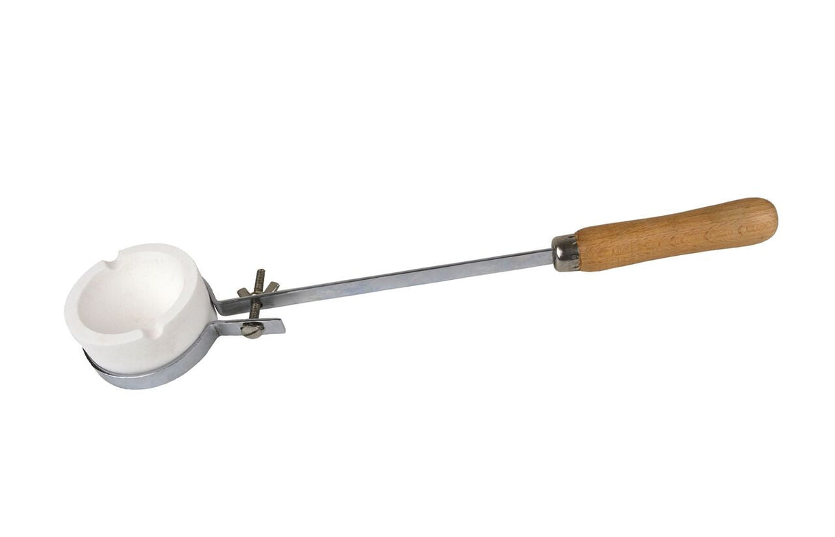 Adjustable fly-nut tongs with wooden handle holding white ceramic crucible for high-temperature melting and casting tasks