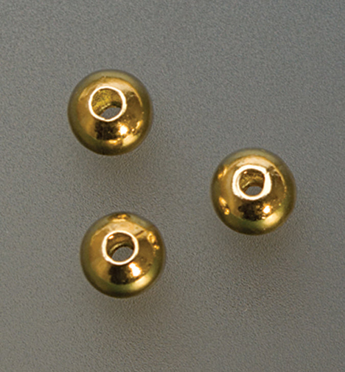 Close-up of three 4mm gold plated seamed bead crimp covers on gray background