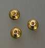 Close-up of three 4mm gold plated seamed bead crimp covers on gray background
