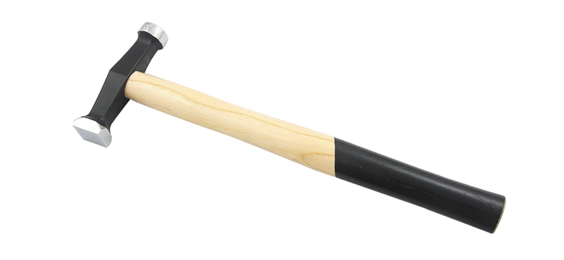 Planishing hammer with wooden handle and dual-faced metal head for metal shaping and finishing